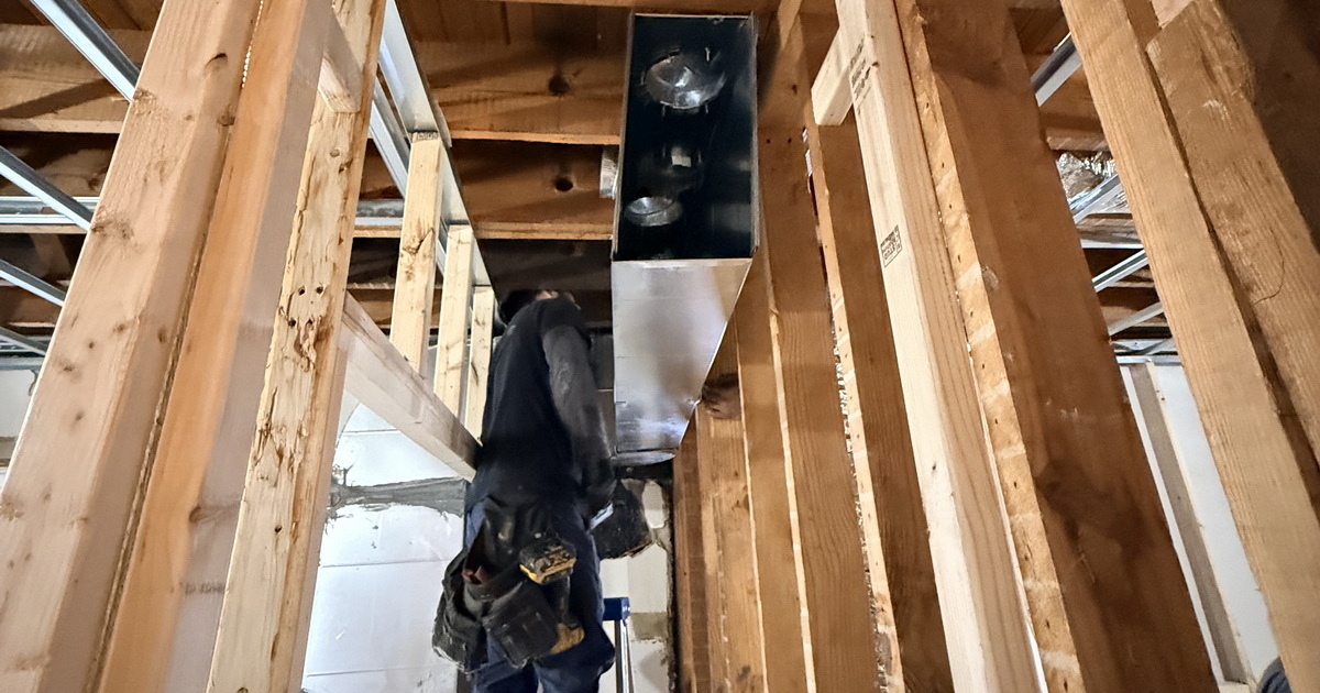 Professional Technician Installing Custom Metal Ducting.jpeg